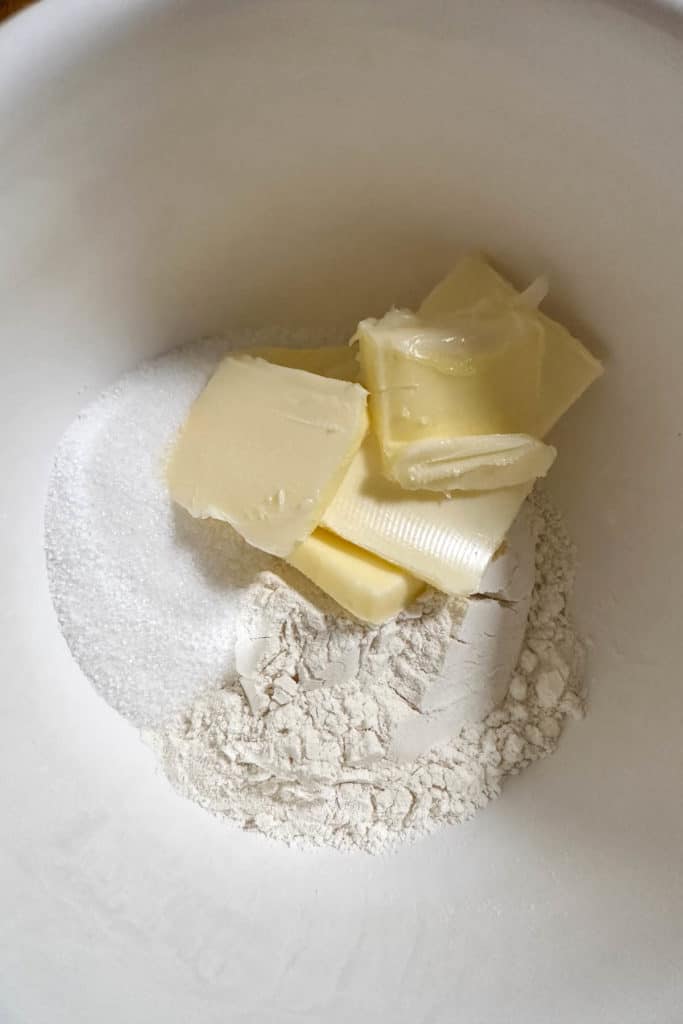 Flour, sugar, and butter in a mixing bowl.