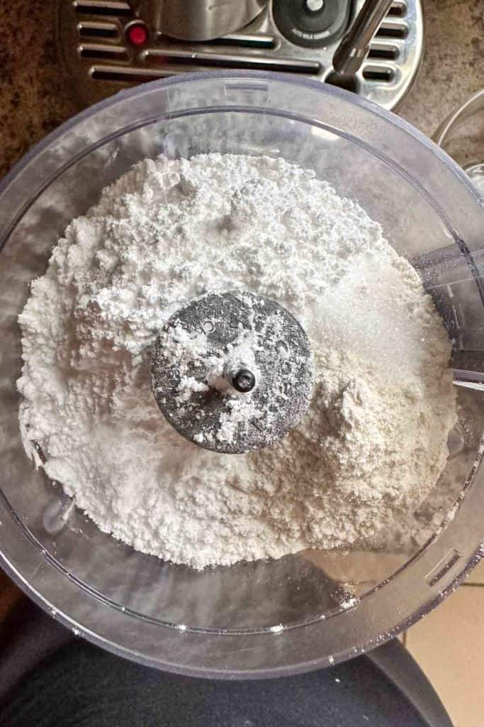 Flour, powdered sugar, and salt in a food processor bowl.