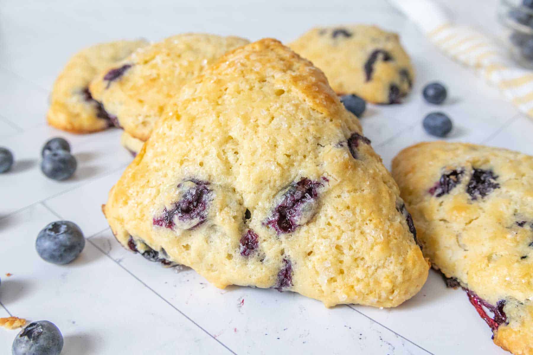 Blueberry scones on a tile surface.