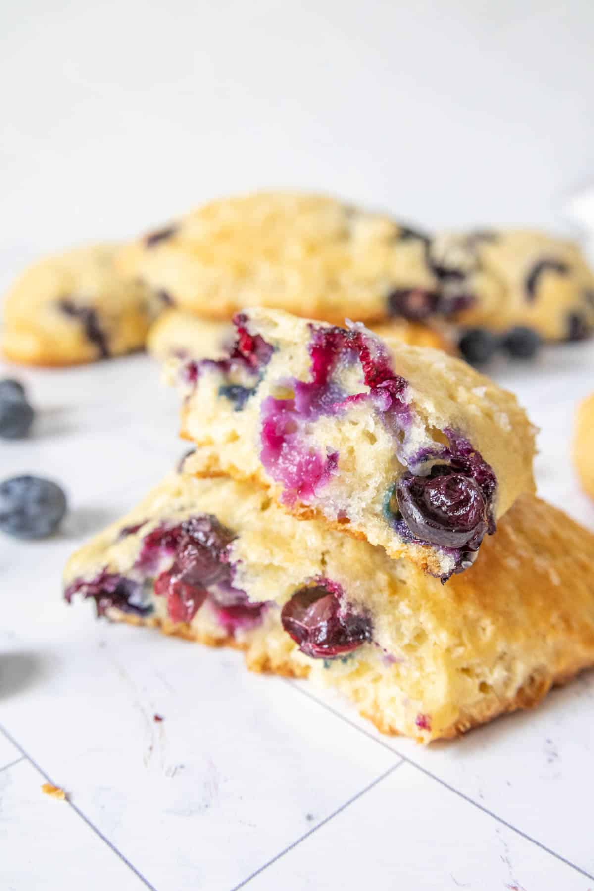 Broken blueberry scone stacked on itself.