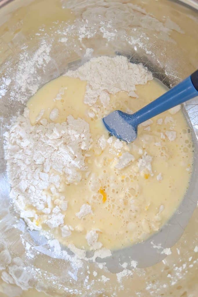 Wet ingredients added to dry before mixing together for scones.