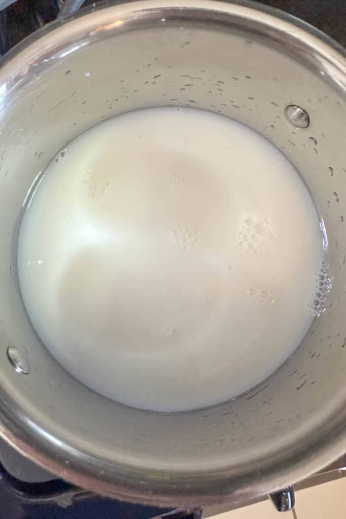 Milk and water in a saucepan.