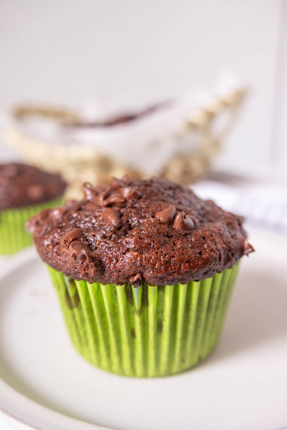 Chocolate zucchini muffin on a plate.