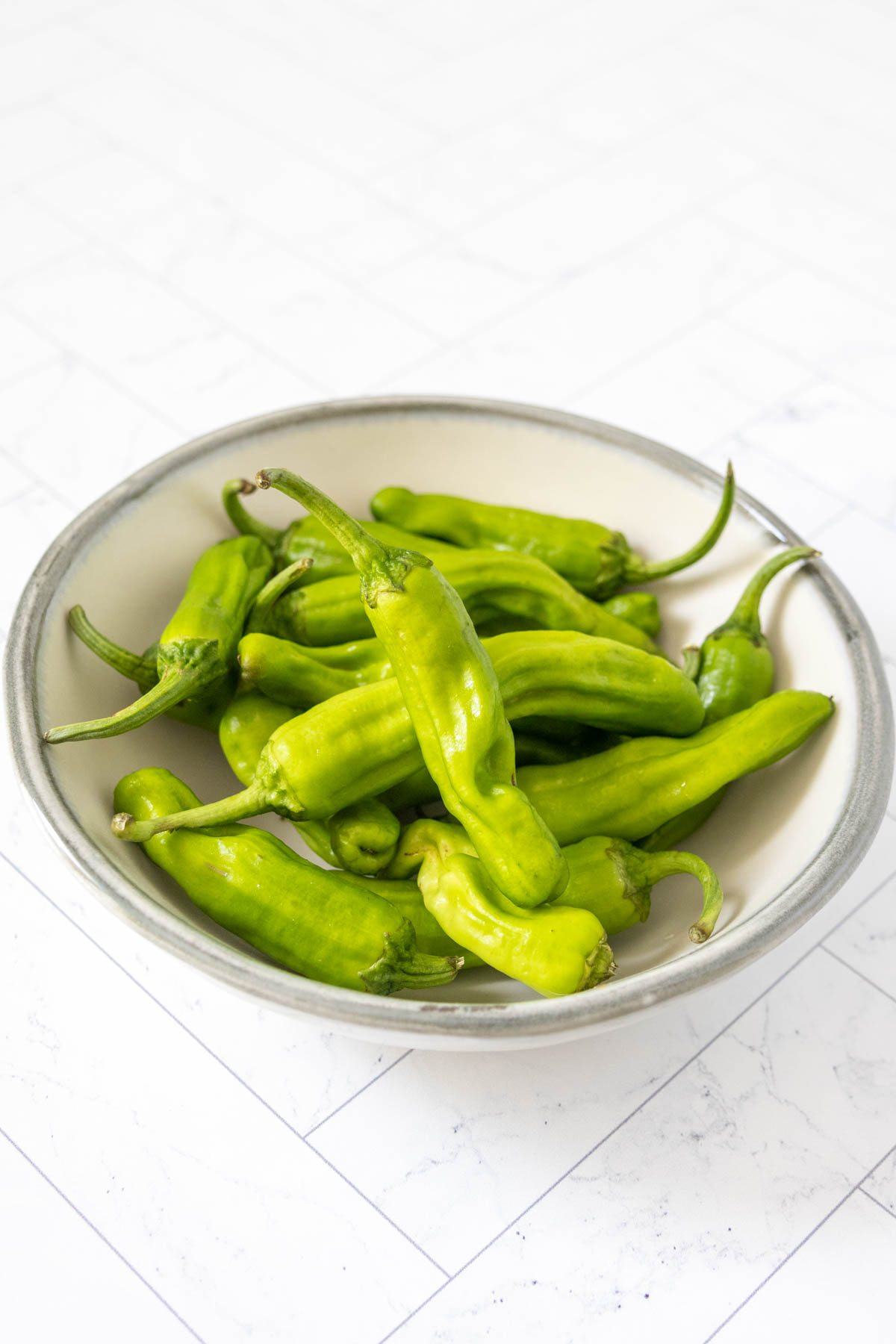 Bowl of shishito peppers.