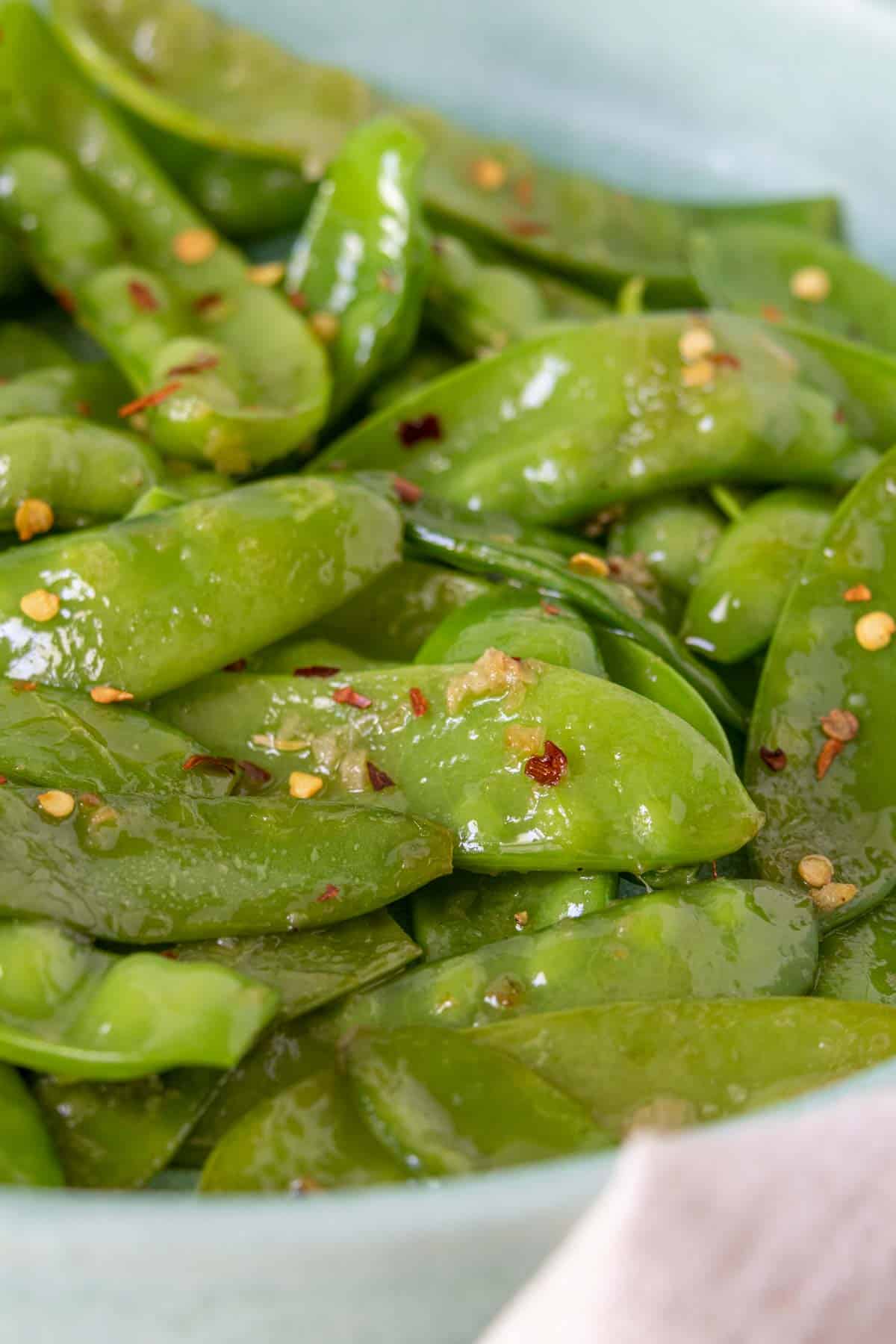 Close up of sautéed snow peas.