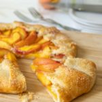 Peach galette with a slice pulled out.