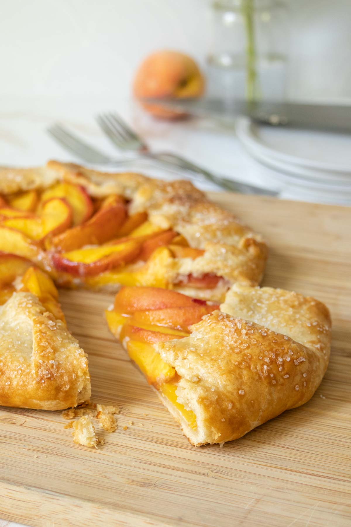 Peach galette with a slice pulled out.