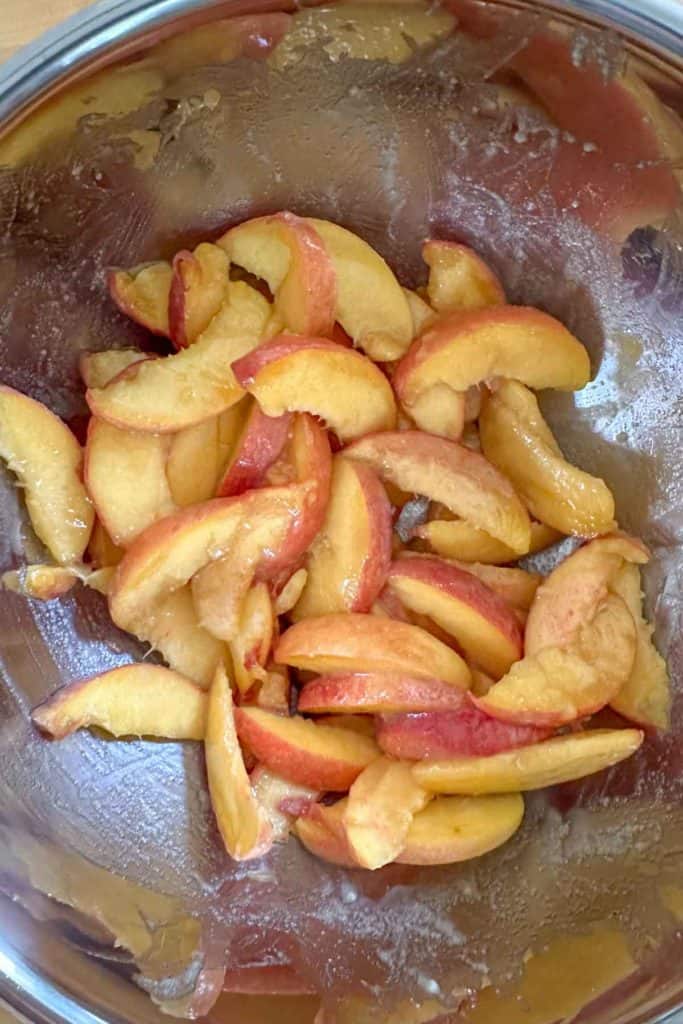 Peaches coated in sugar, flour, vanilla, and lemon juice.