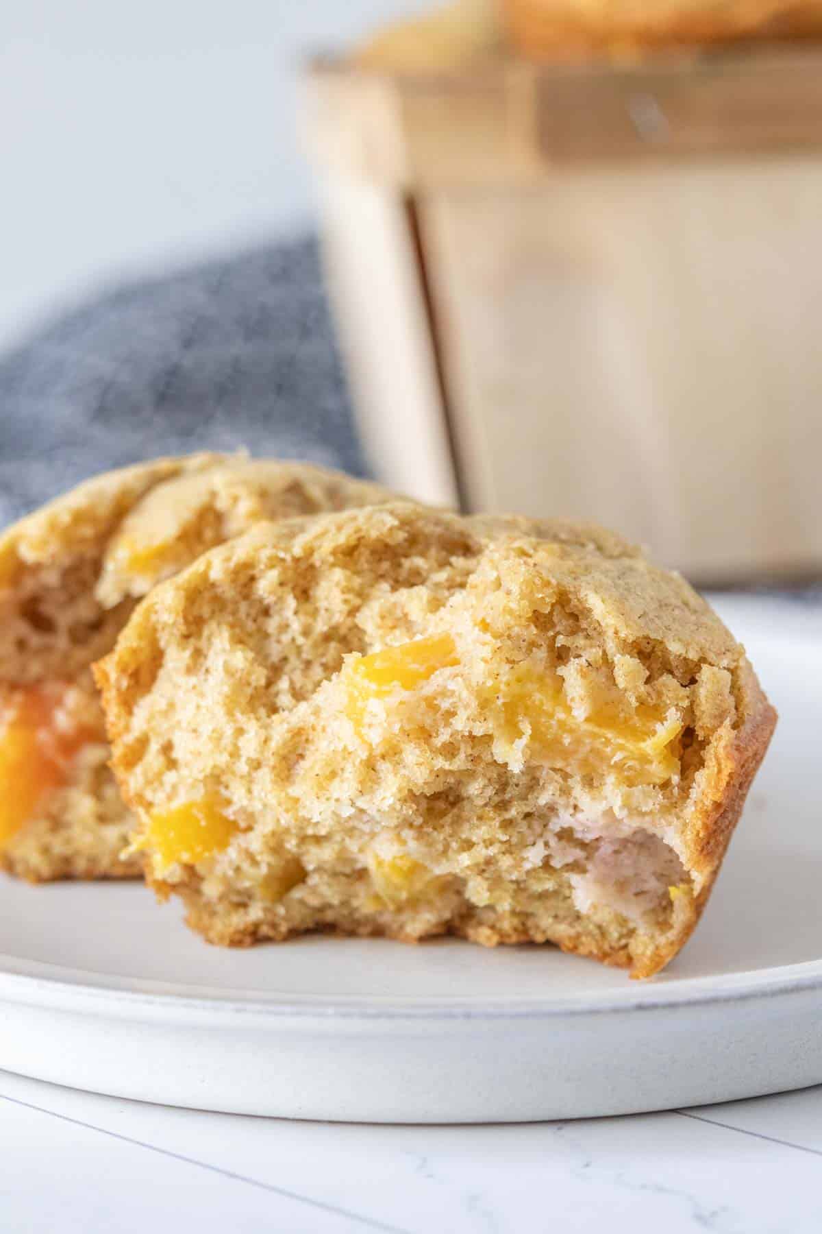 Peach muffin broken into two halves to see the interior.