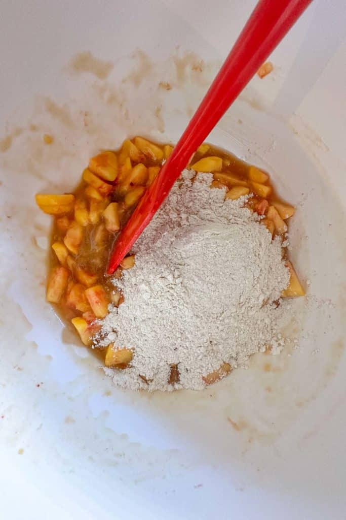 Stirring dry ingredients into muffin batter.
