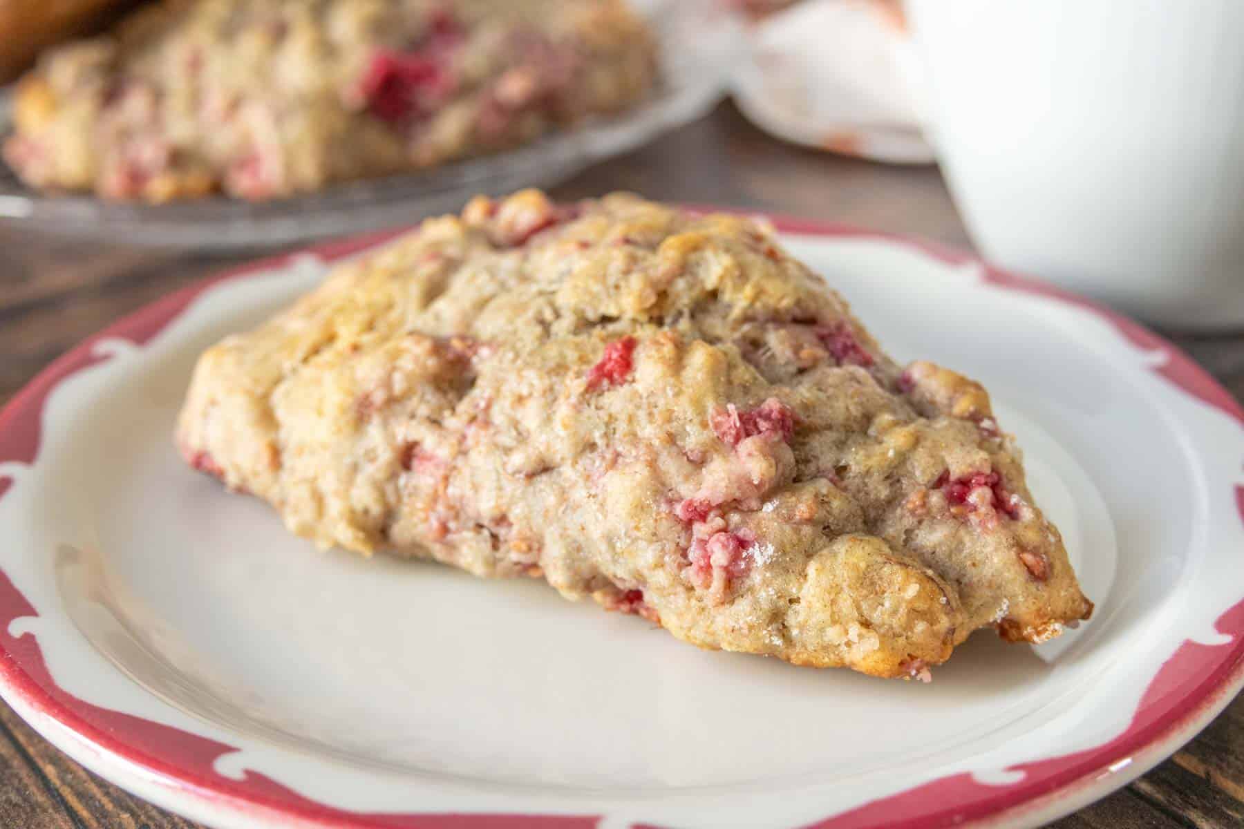 Raspberry scone on a small plate.