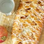 A braided apple pastry on a baking sheet.