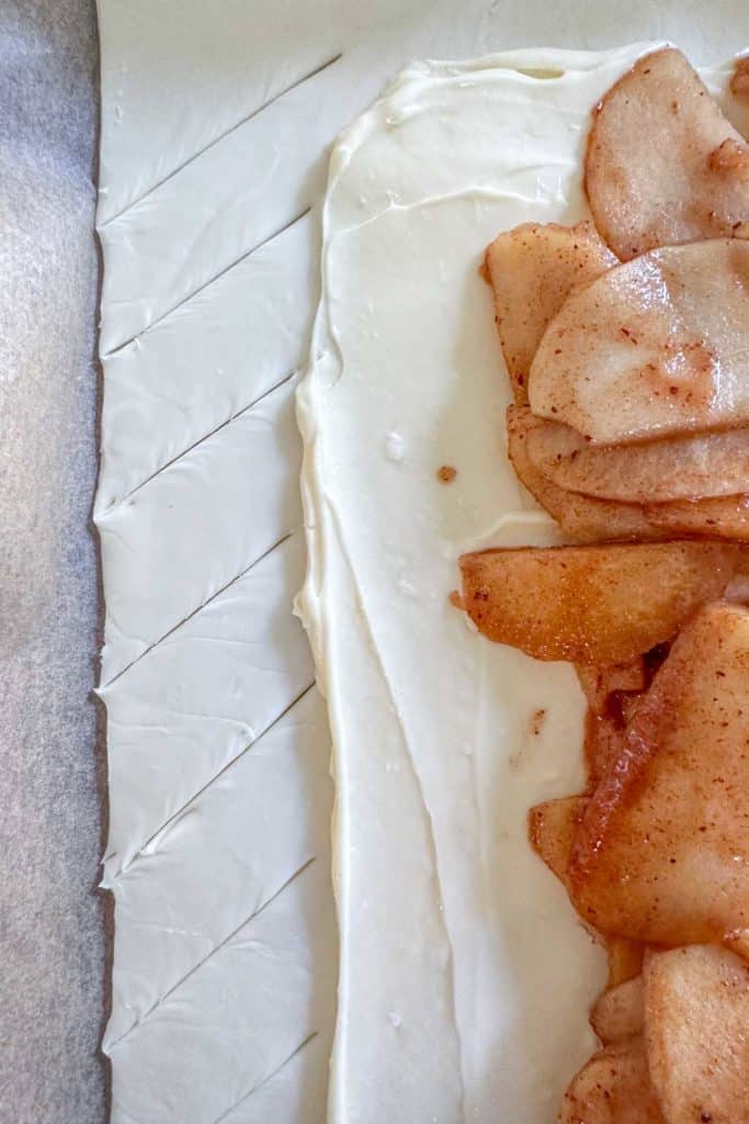 Unbaked apple pastry showing insides before braiding.