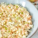 Apple coleslaw in a blue bowl.