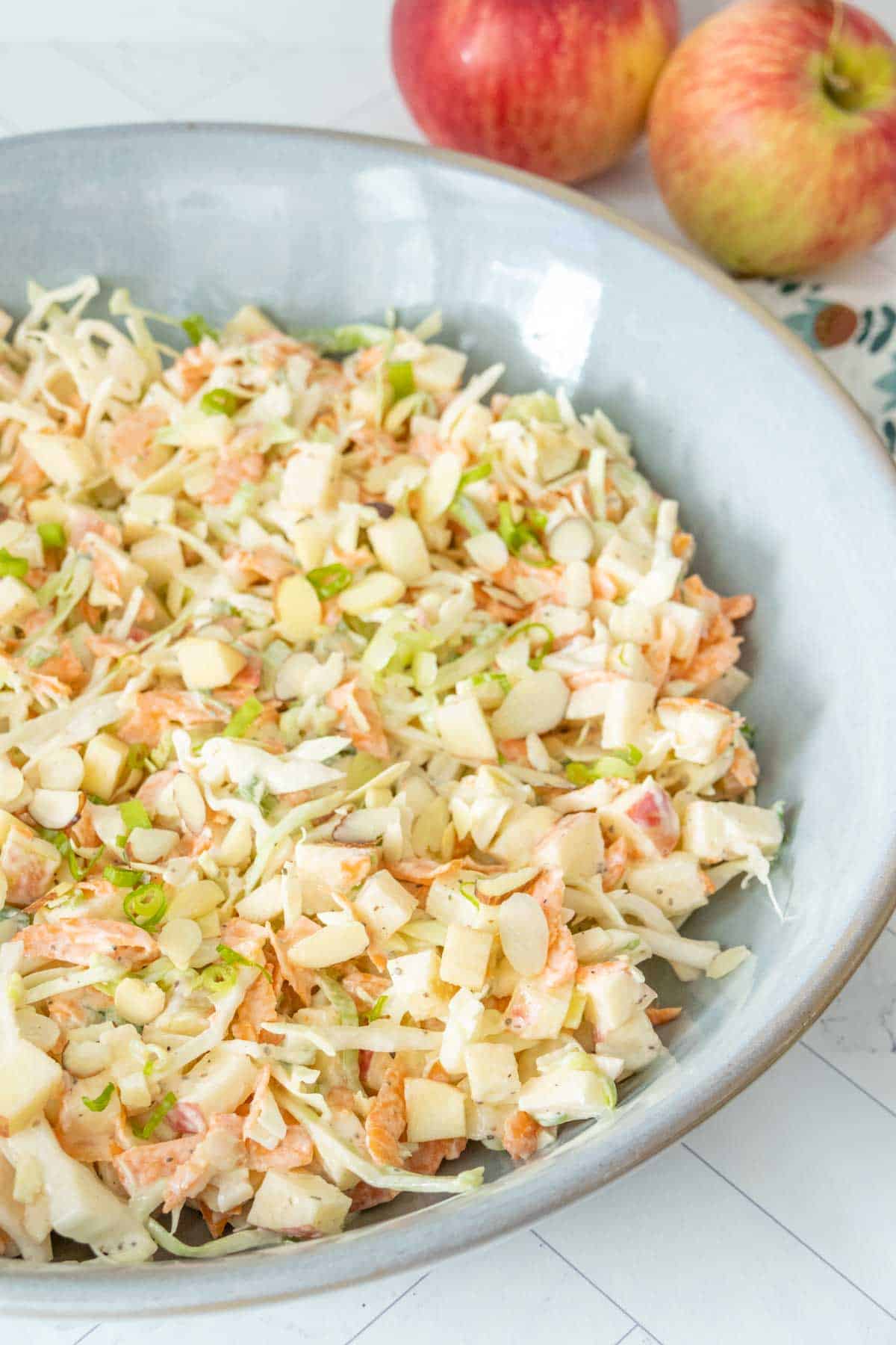 Apple coleslaw in a blue bowl.