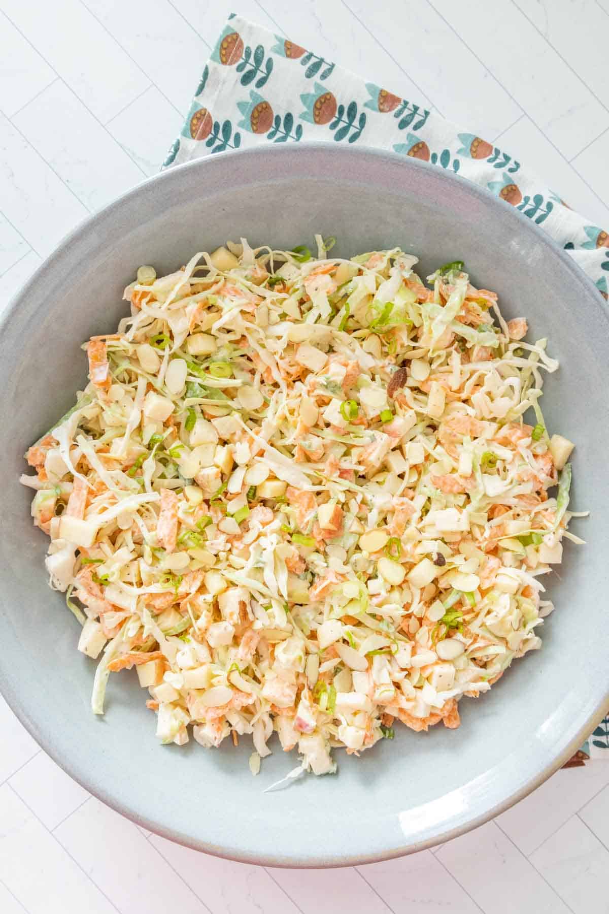 A bowl of slaw with carrots and celery.