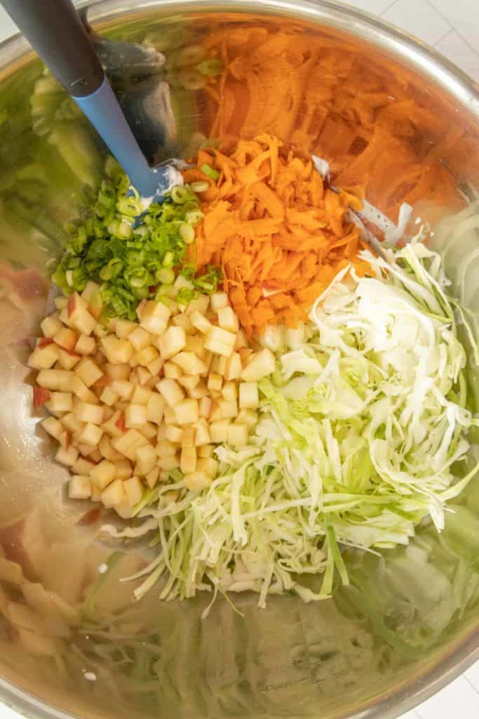 A bowl of chopped vegetables in a silver bowl.