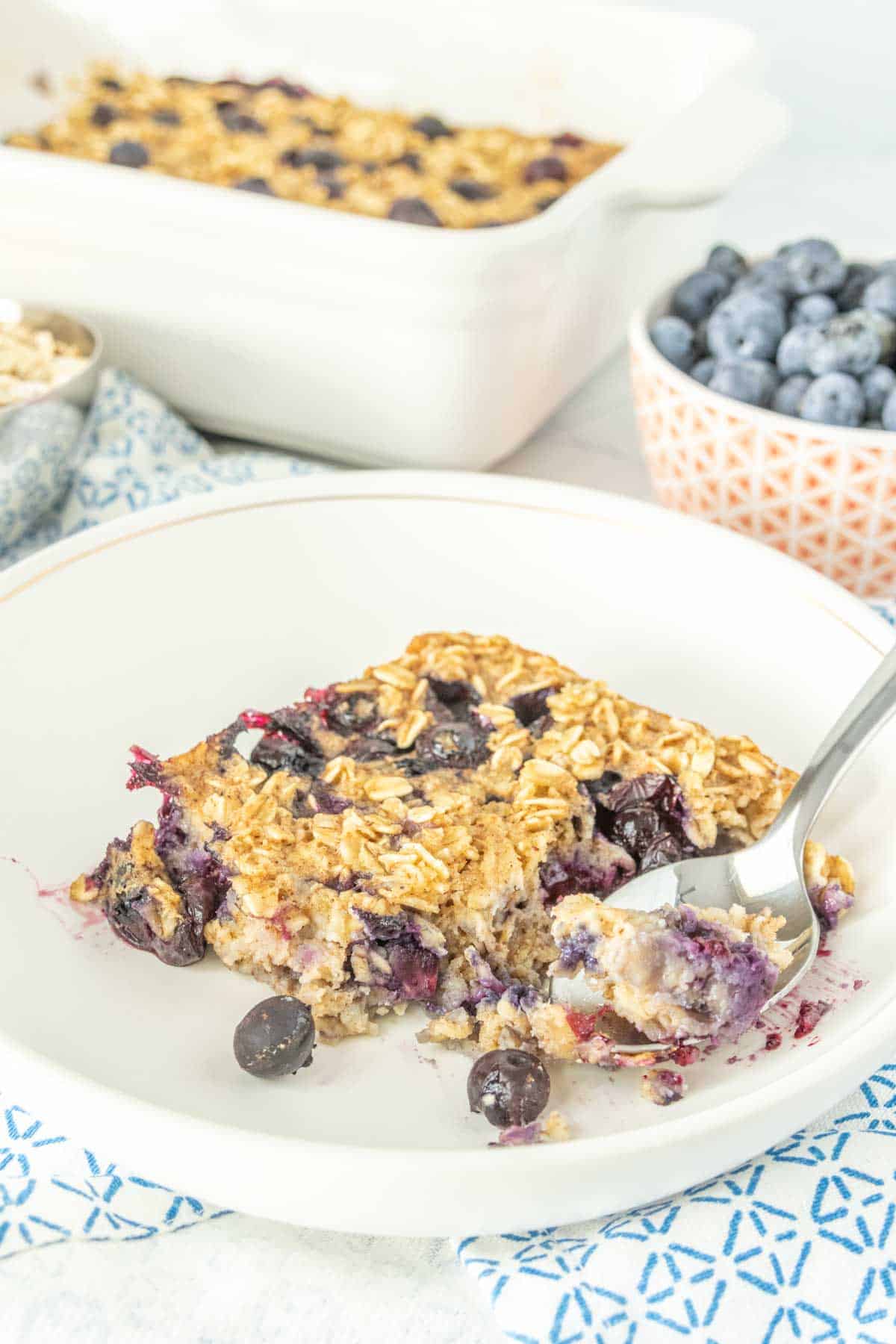 Baked oatmeal with blueberries on a plate with a spoon.