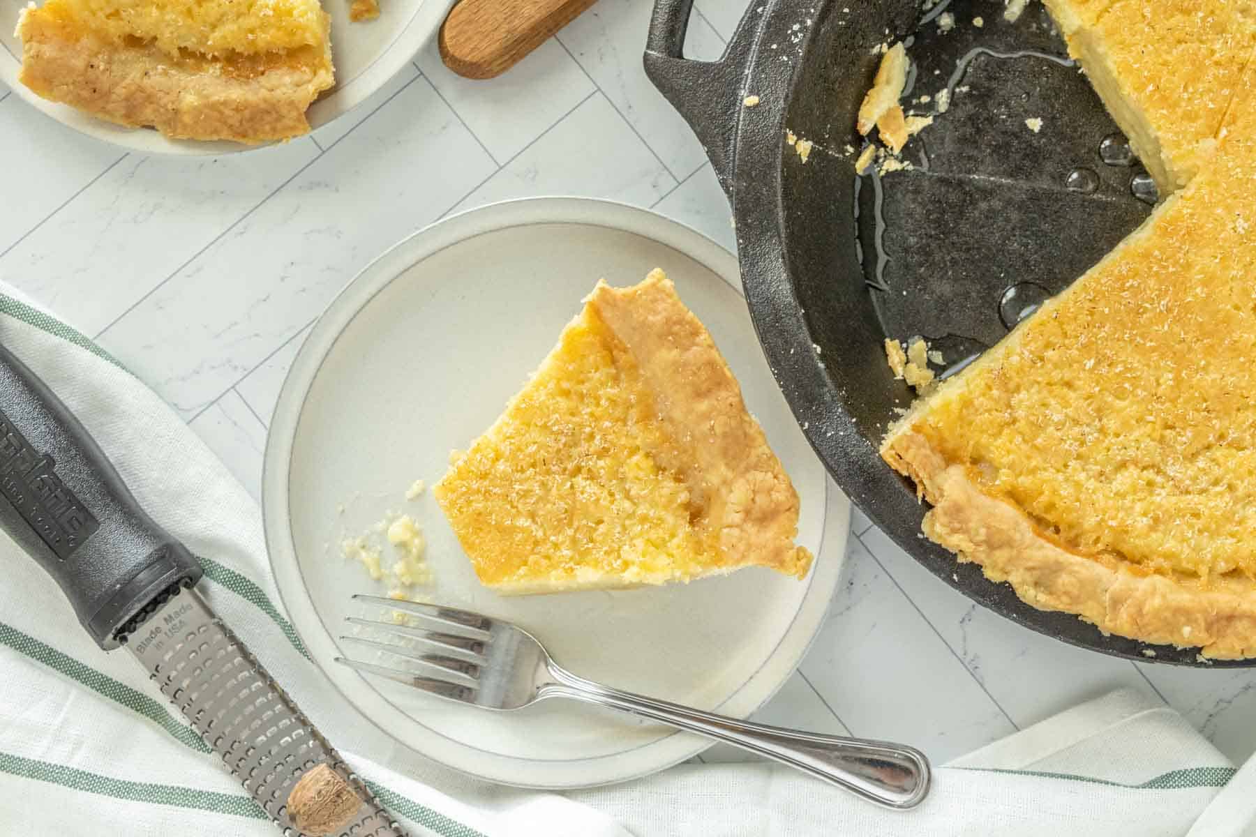 A slice of pie on a plate with a knife and fork.