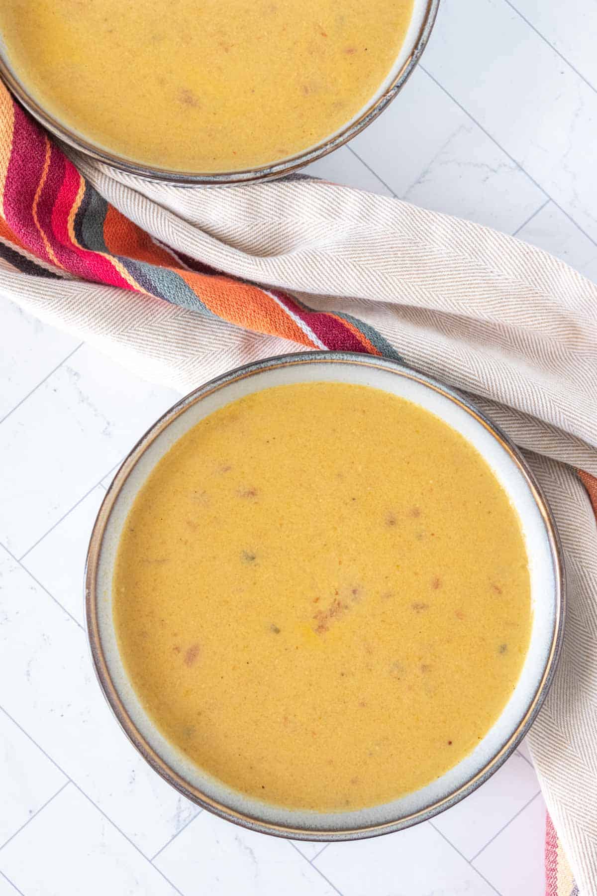 Corn soup gray bowls from overhead.