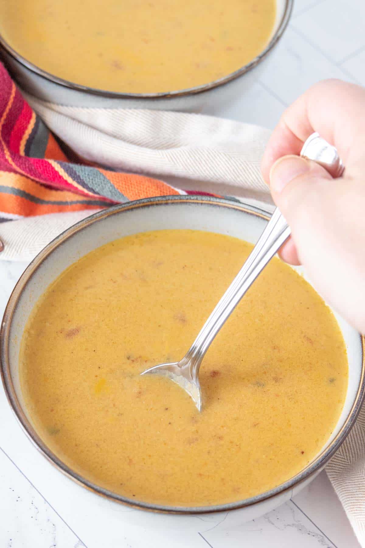 Stirring a bowl of corn soup.