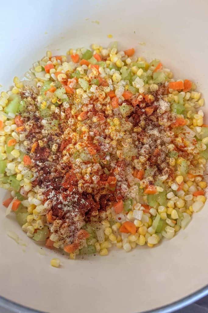 Spices added to vegetables for corn soup before mixing.