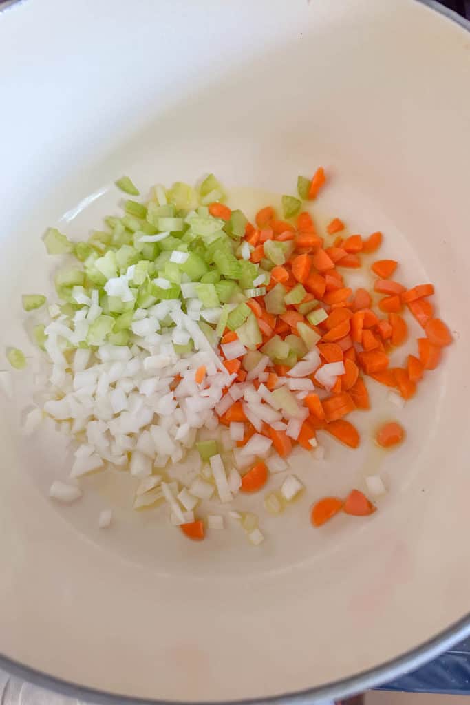 Onion, carrots, and celery in a pot with olive oil to sauté.