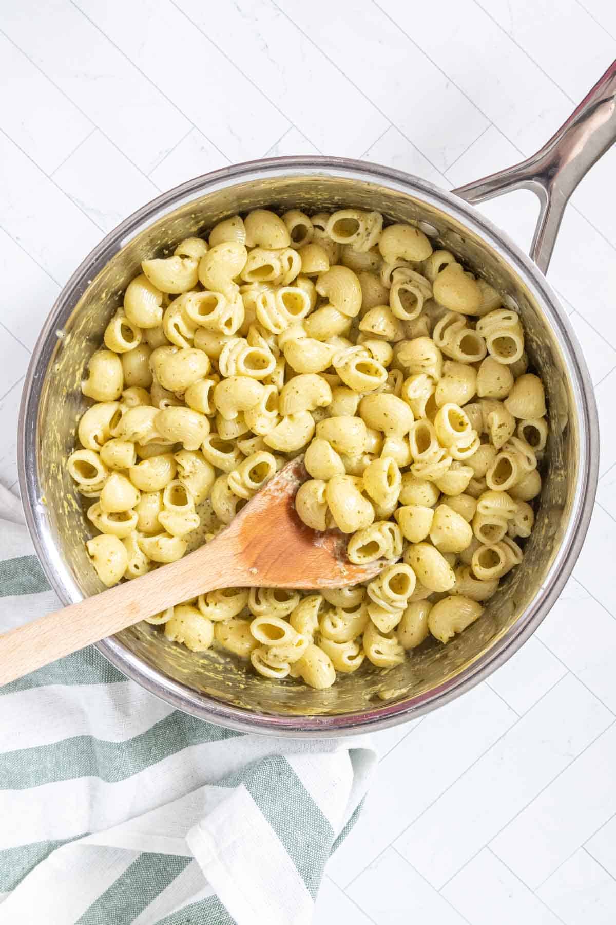 Overhead of creamy pesto pasta in a skillet.