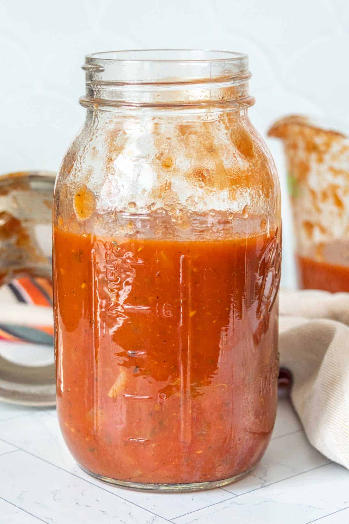 Homemade tomato sauce in a mason jar.