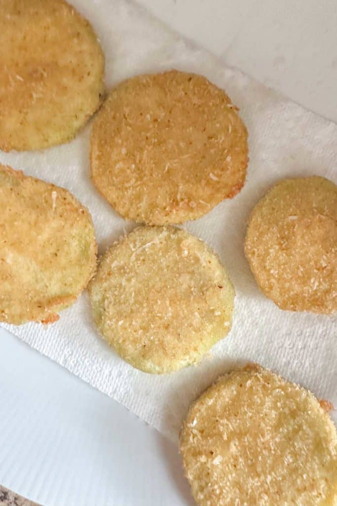 Fried eggplant on a paper towel plate.