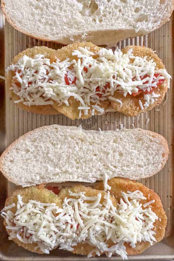 Cheese on top of eggplant parmesan sandwich.