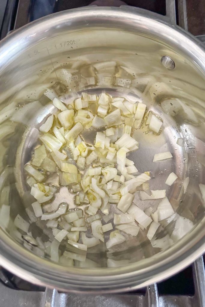 Sautéing onions in a saucepan.