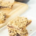 Fig bars with oats and figs on a white plate.