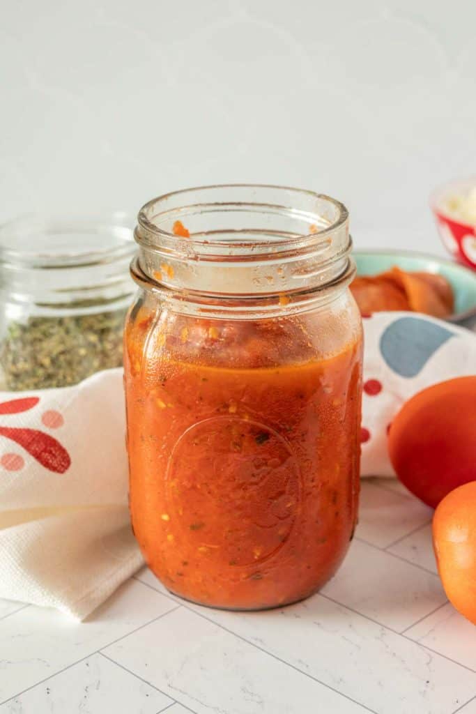 Homemade pizza sauce in a mason jar.