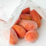 Frozen tomatoes in a plastic bag.