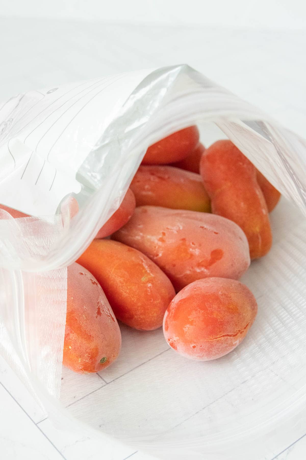 Frozen tomatoes in a plastic bag.