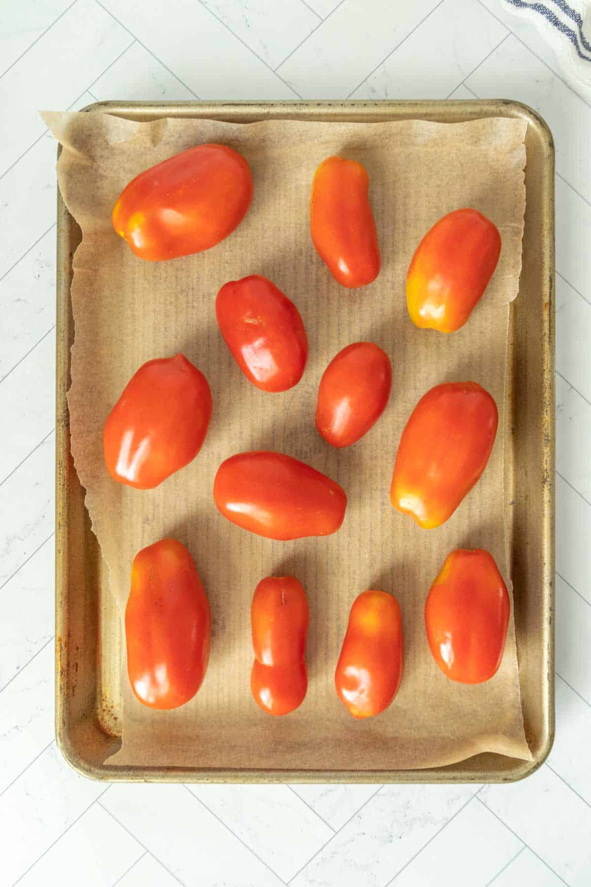 San Marzano tomatoes on a baking sheet.