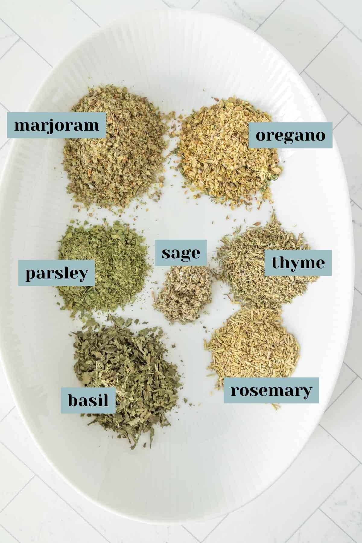 Herbs and spices on a white plate.
