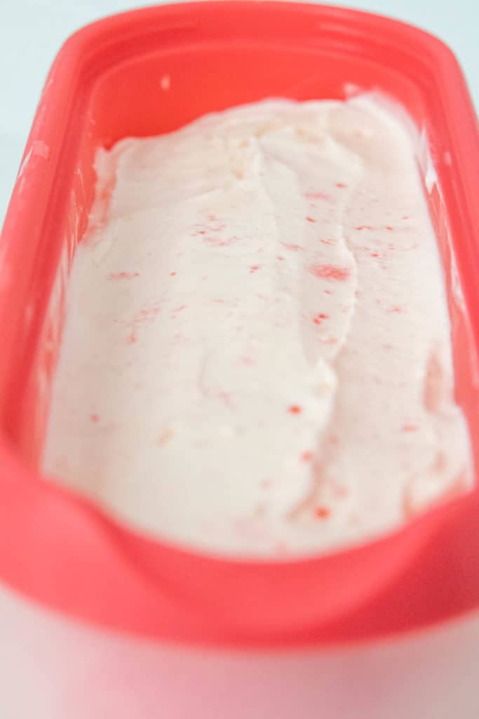 An ice cream container filled with peppermint ice cream.