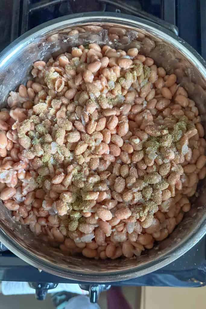 A pot of beans on top of a stove.