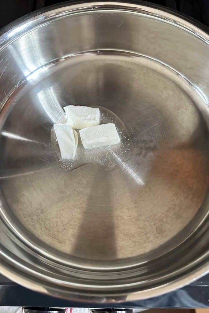 Shortening in a pan on top of a stove.