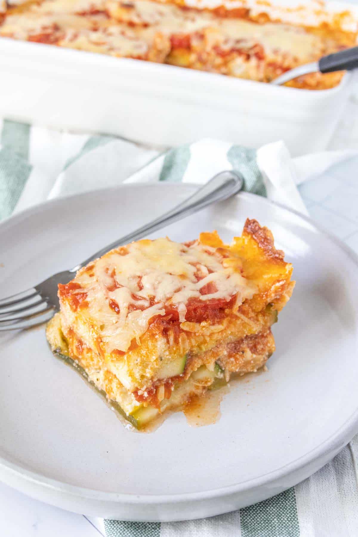 Slice of zucchini lasagna on a gray plate.