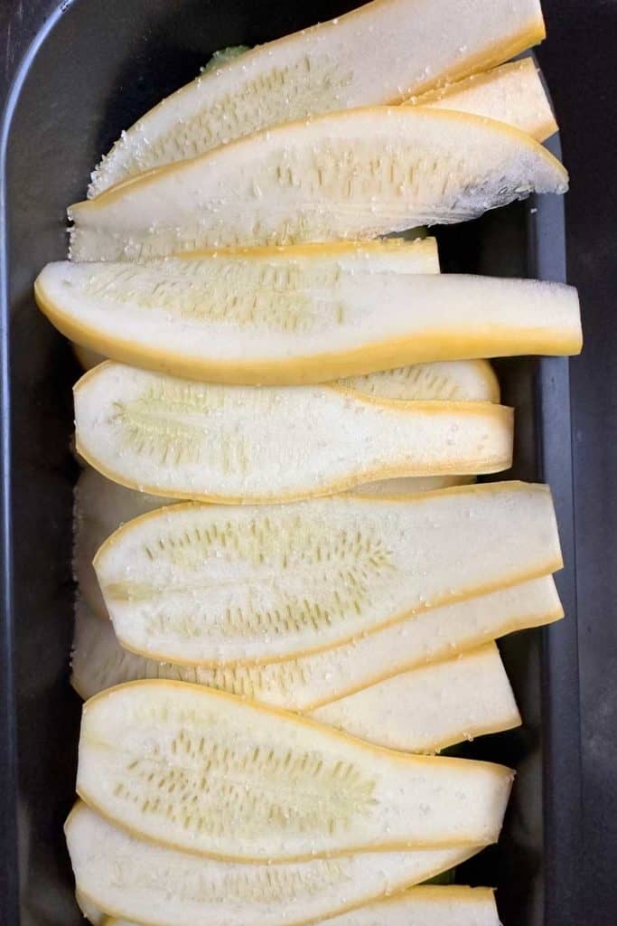 Salted summer squash in a colander.