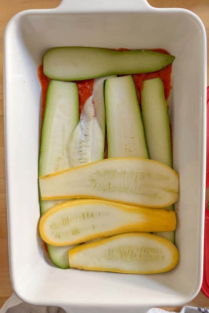 Layering zucchini and summer squash in a casserole for lasagna.