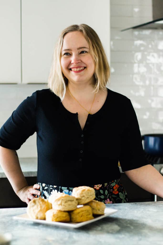 White woman in a black shirt looking off to the side.
