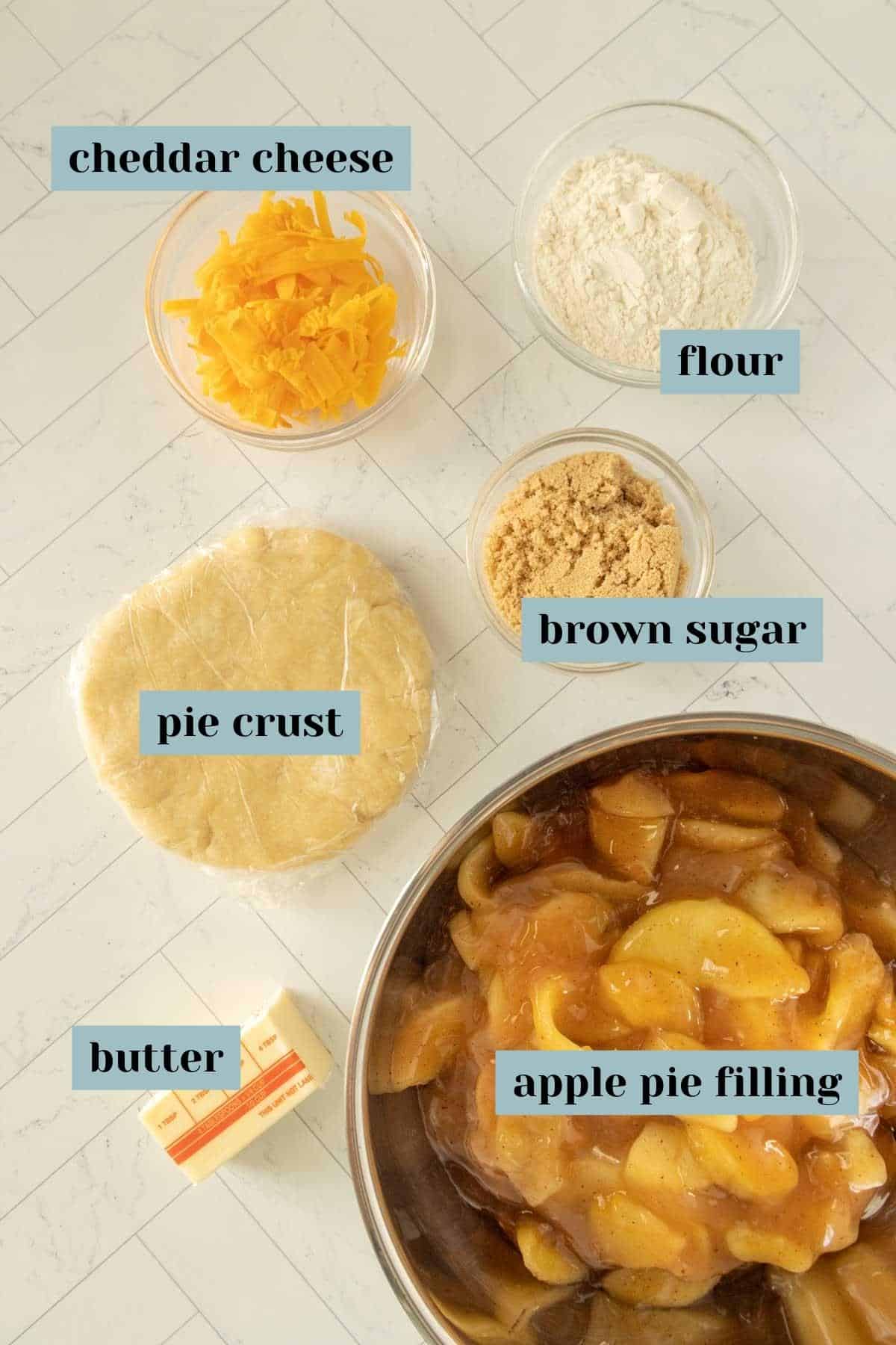 The ingredients for apple pie are shown on a white countertop.