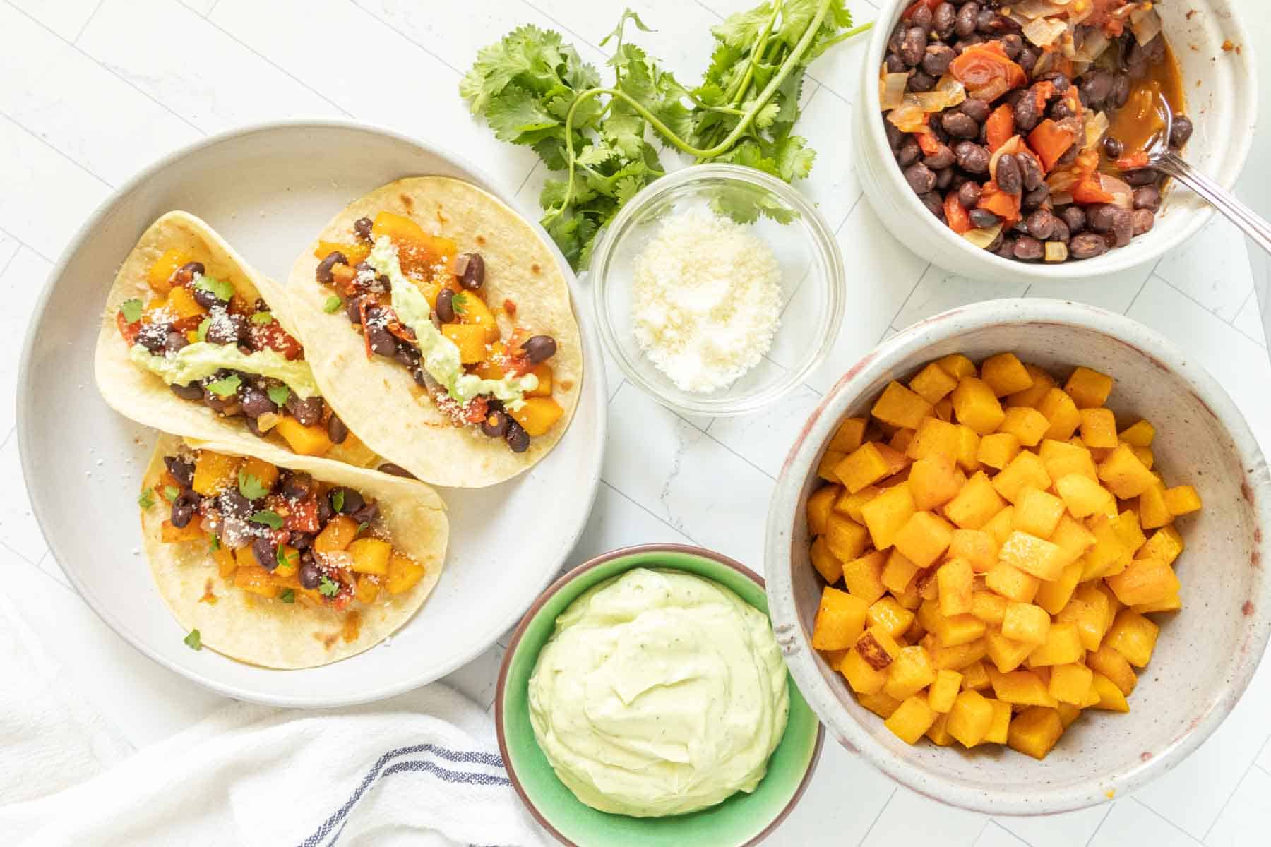 Mexican tacos with black beans, squash and guacamole.