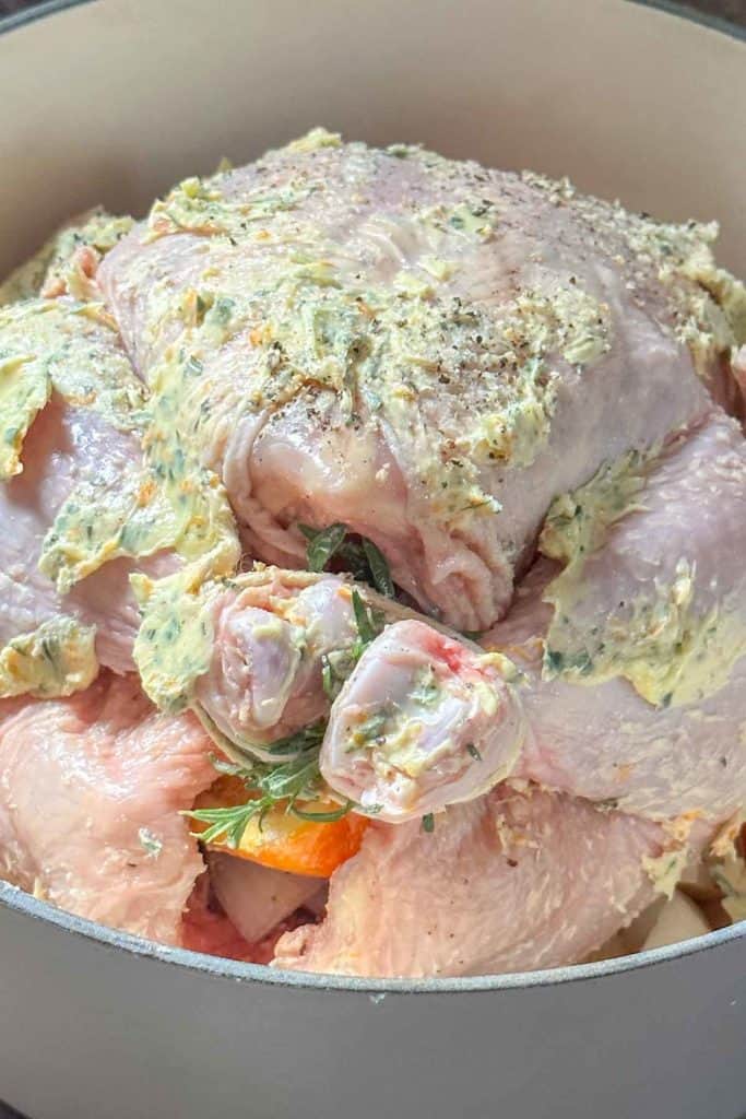 Chicken in a pan with herbs and spices.