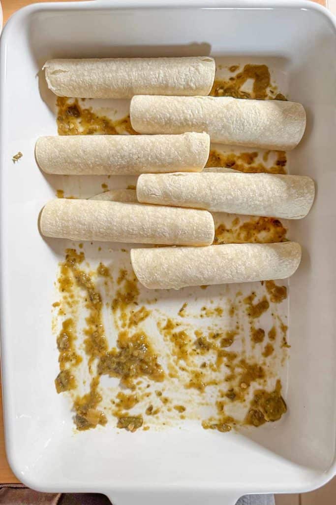 Mexican enchiladas in a white baking dish.