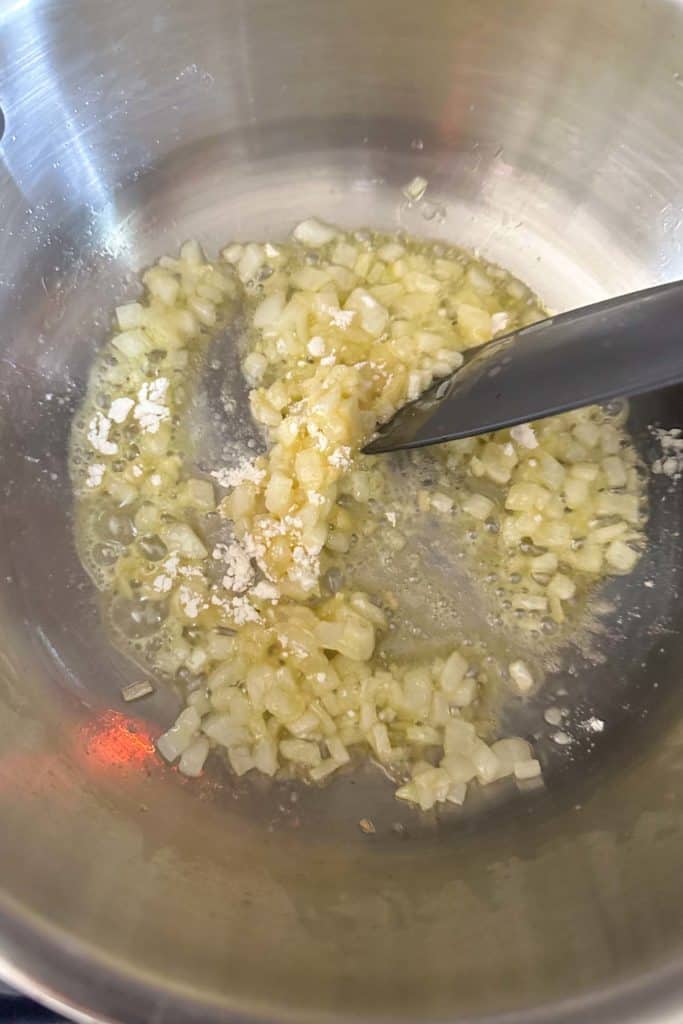 A pan with onions and garlic in it.